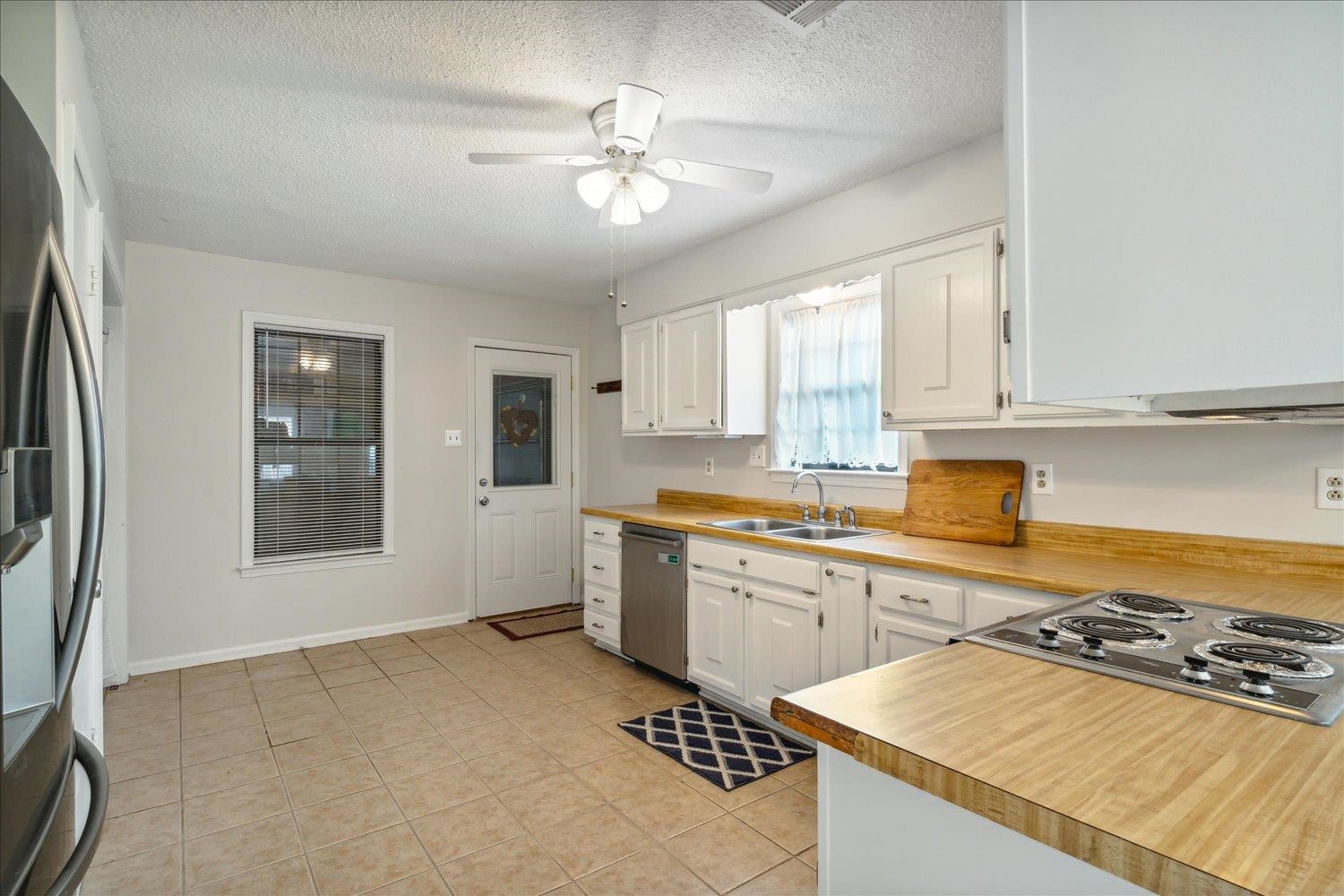 4419 Logan's Path Road Millington, TN 38053 - Photo 17 of 21 a kitchen with stainless steel appliances granite countertop a stove a sink dishwasher and a refrigerator with wooden floor