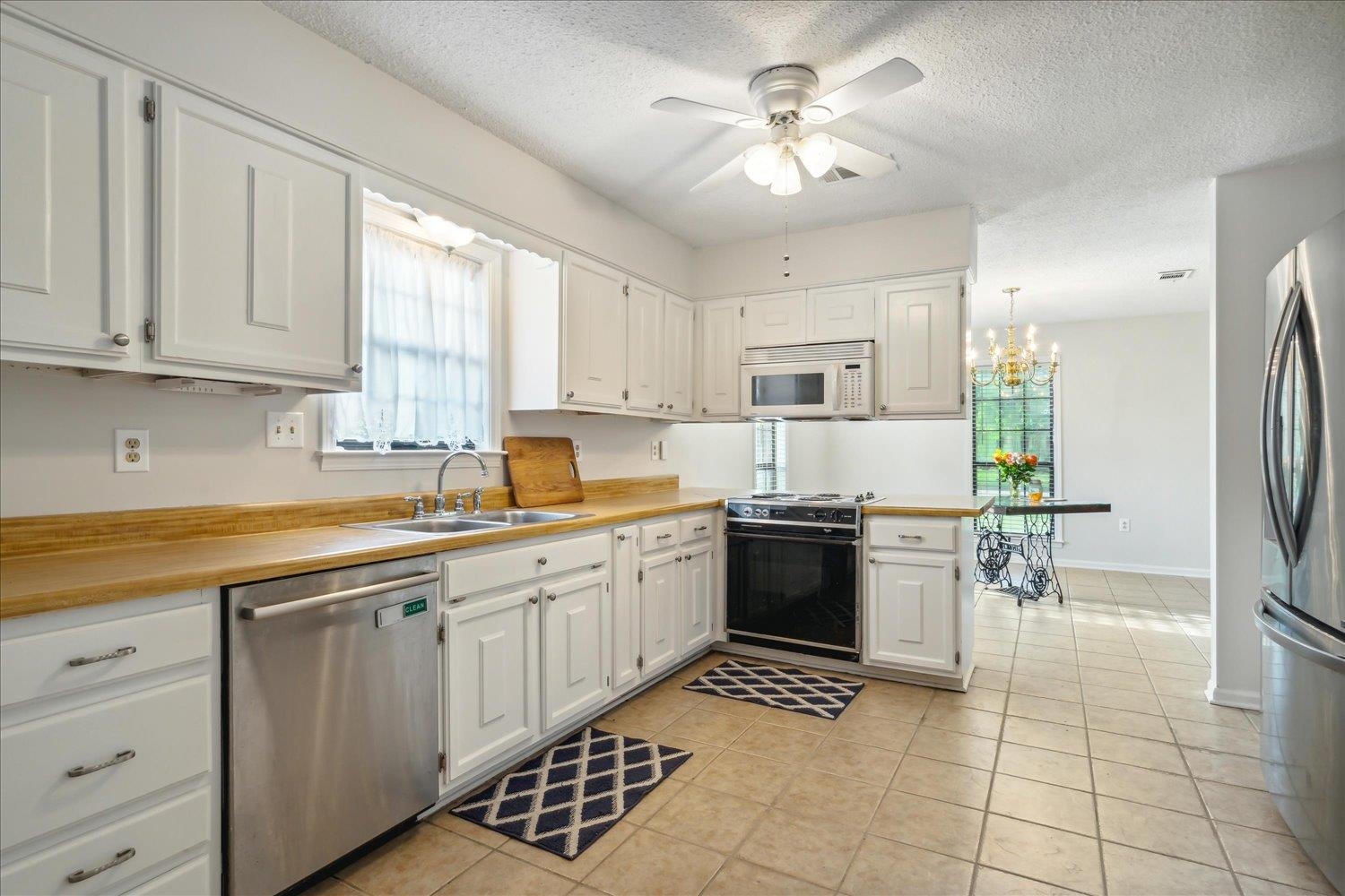 4419 Logan's Path Road Millington, TN 38053 - Photo 19 of 21 a kitchen with a stove a sink and a refrigerator