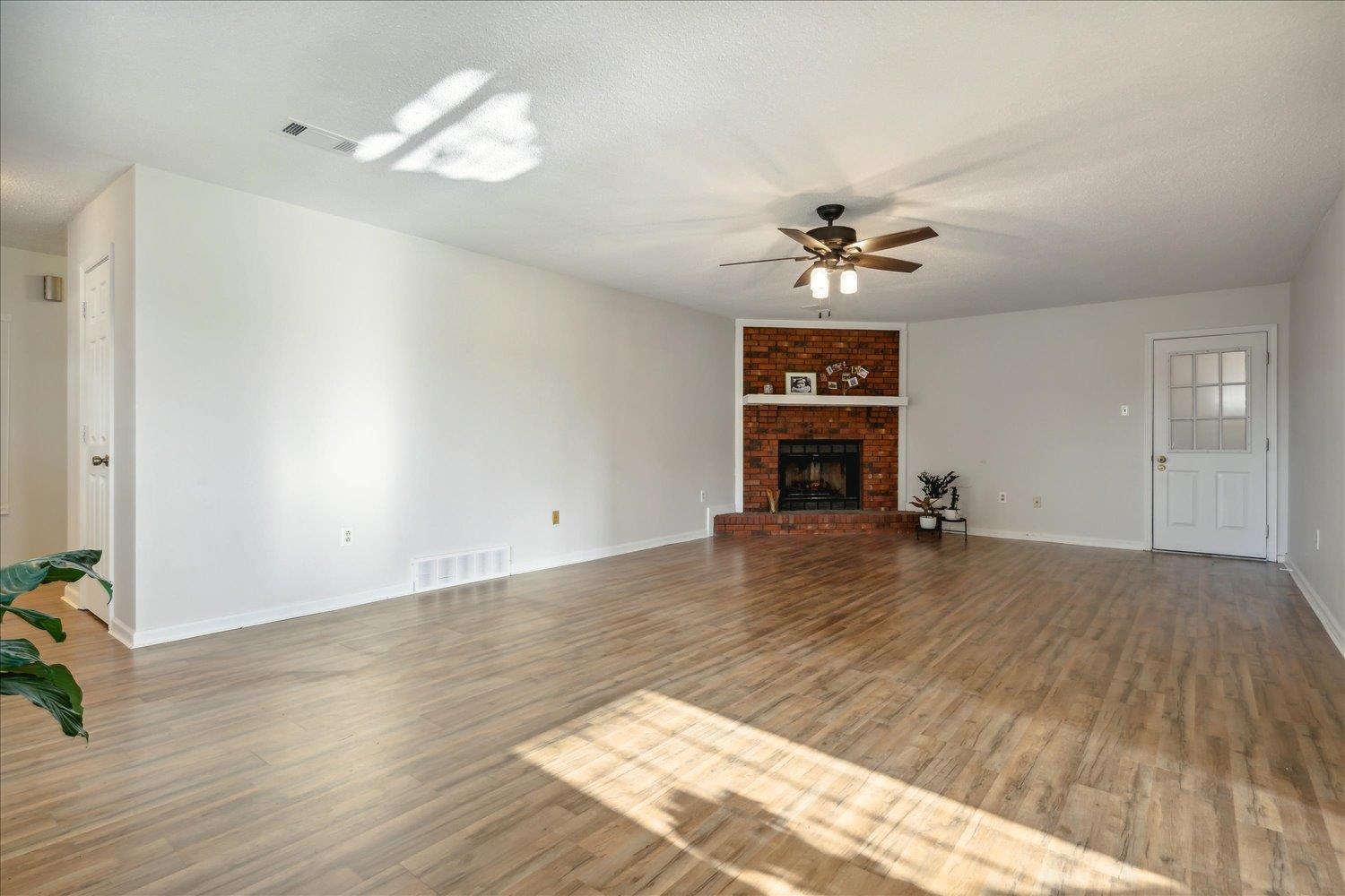 4419 Logan's Path Road Millington, TN 38053 - Photo 9 of 21 wooden floor in an empty room with a window
