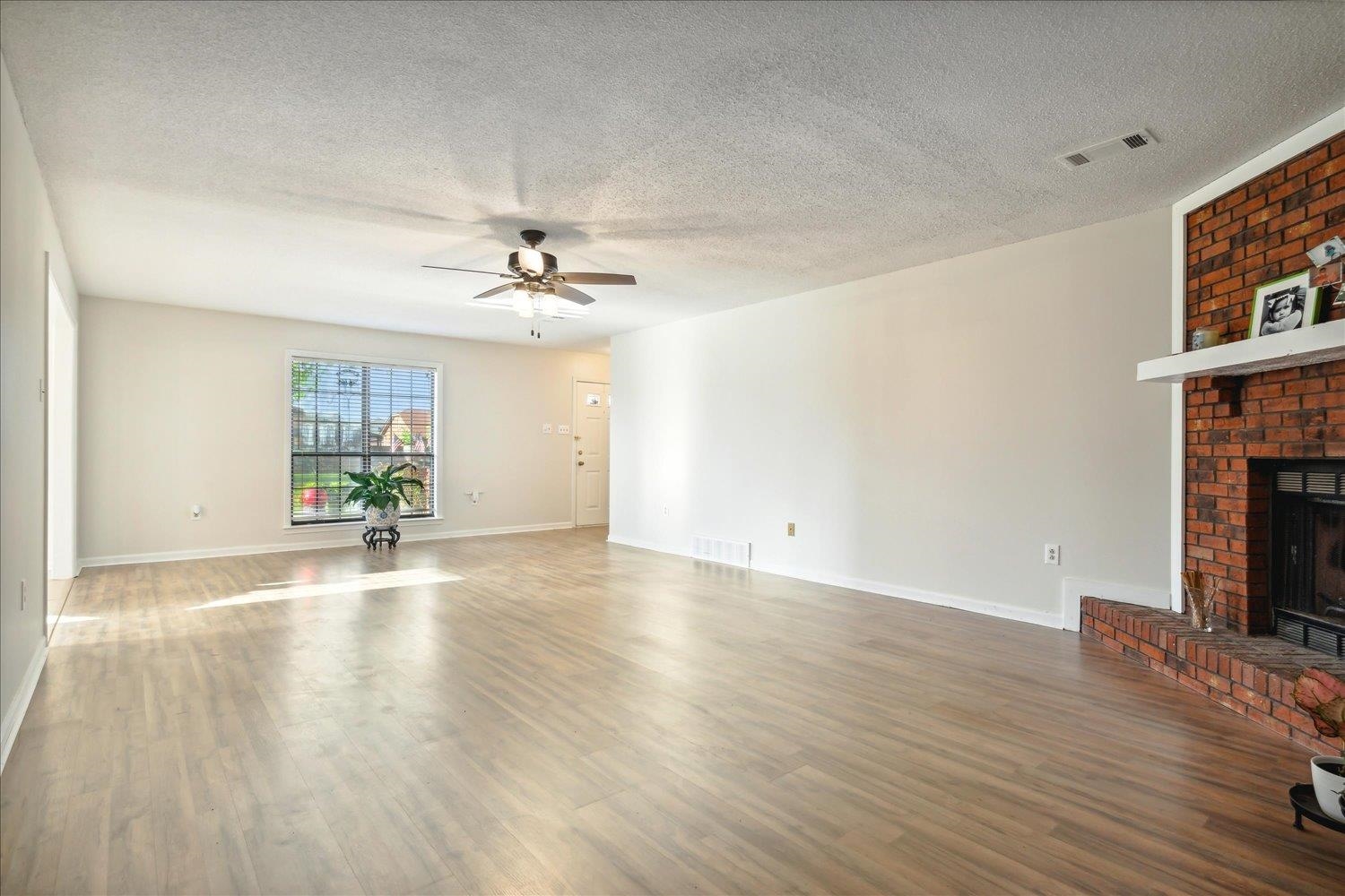 4419 Logan's Path Road Millington, TN 38053 - Photo 10 of 21 a view of a livingroom with wooden floor and a ceiling fan