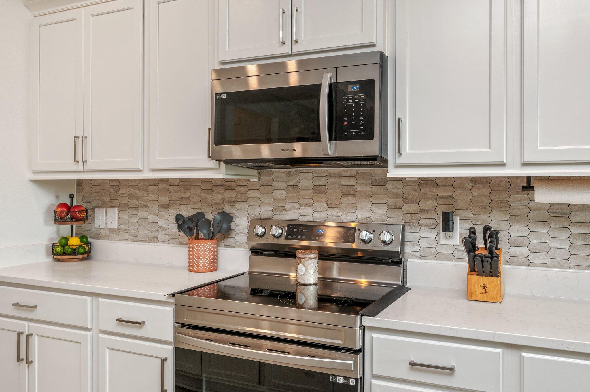 134 Blooming Cove Crestview, FL 32539 - Photo 14 of 50 a kitchen with a microwave and white cabinets