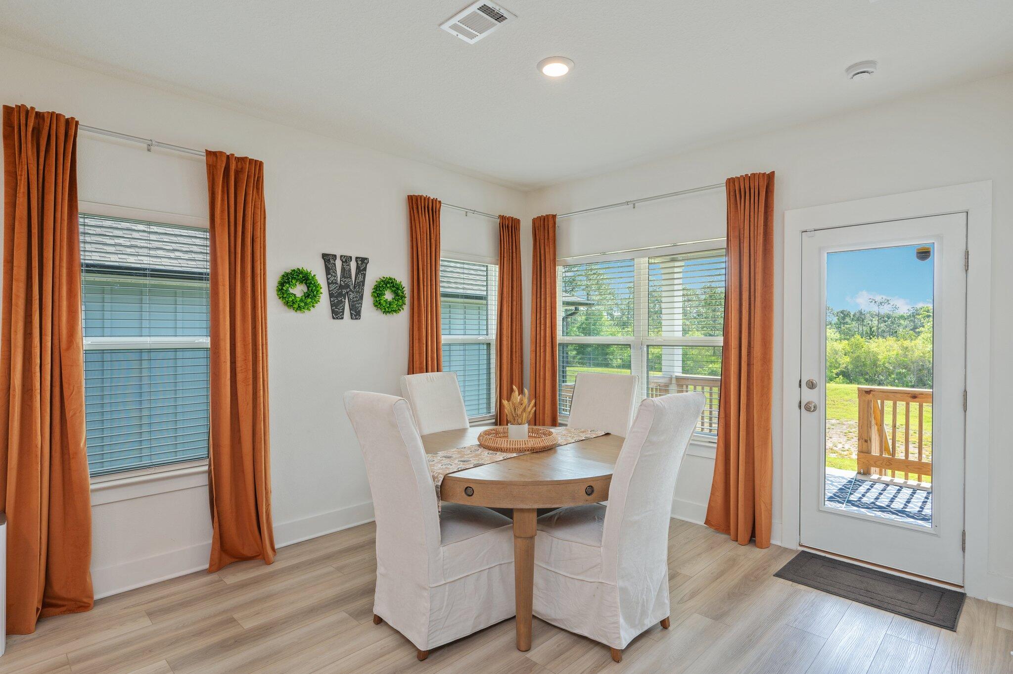 134 Blooming Cove Crestview, FL 32539 - Photo 17 of 50 a view of a dining room with furniture window and wooden floor
