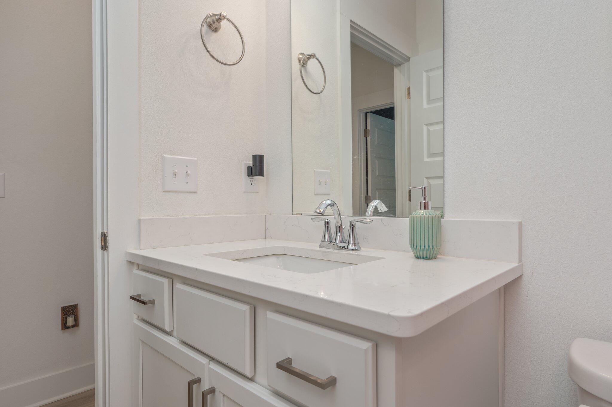 134 Blooming Cove Crestview, FL 32539 - Photo 36 of 50 a bathroom with a granite countertop sink and a mirror