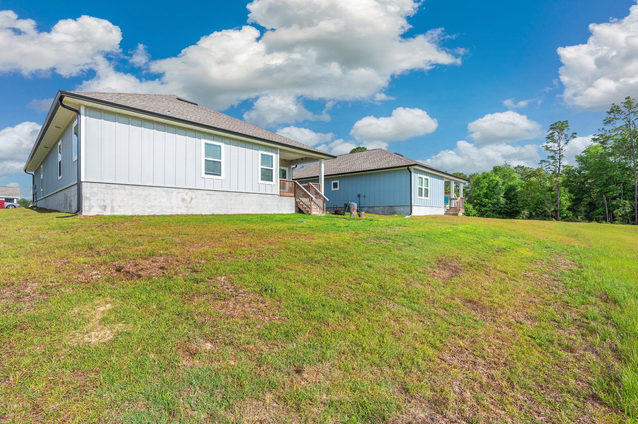 134 Blooming Cove Crestview, FL 32539 - Photo 48 of 50 a view of a house with a yard
