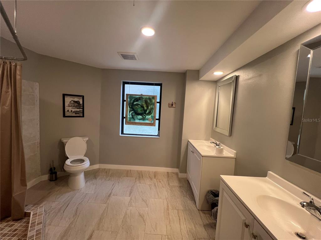 129 Northshore Terrace Punta Gorda, FL 33980 - Photo 12 of 37 a bathroom with a sink mirror vanity and toilet