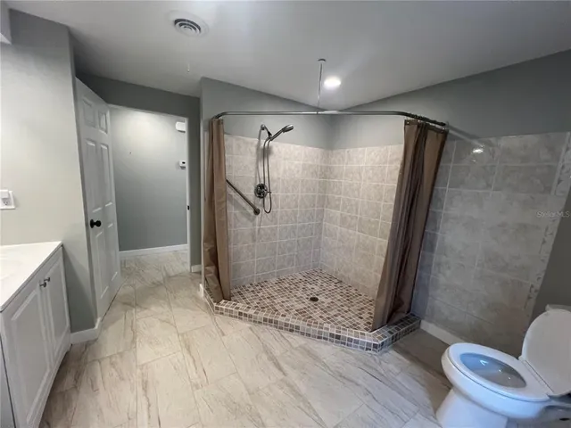a bathroom with a shower and a toilet