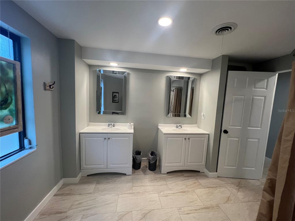 129 Northshore Terrace Punta Gorda, FL 33980 - Photo 14 of 37 a bathroom with a double vanity sink and mirror