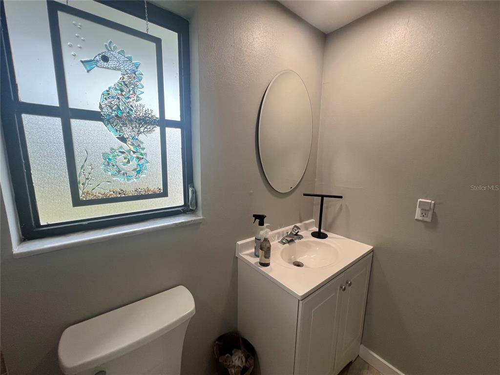 129 Northshore Terrace Punta Gorda, FL 33980 - Photo 20 of 37 a bathroom with a sink mirror and toilet
