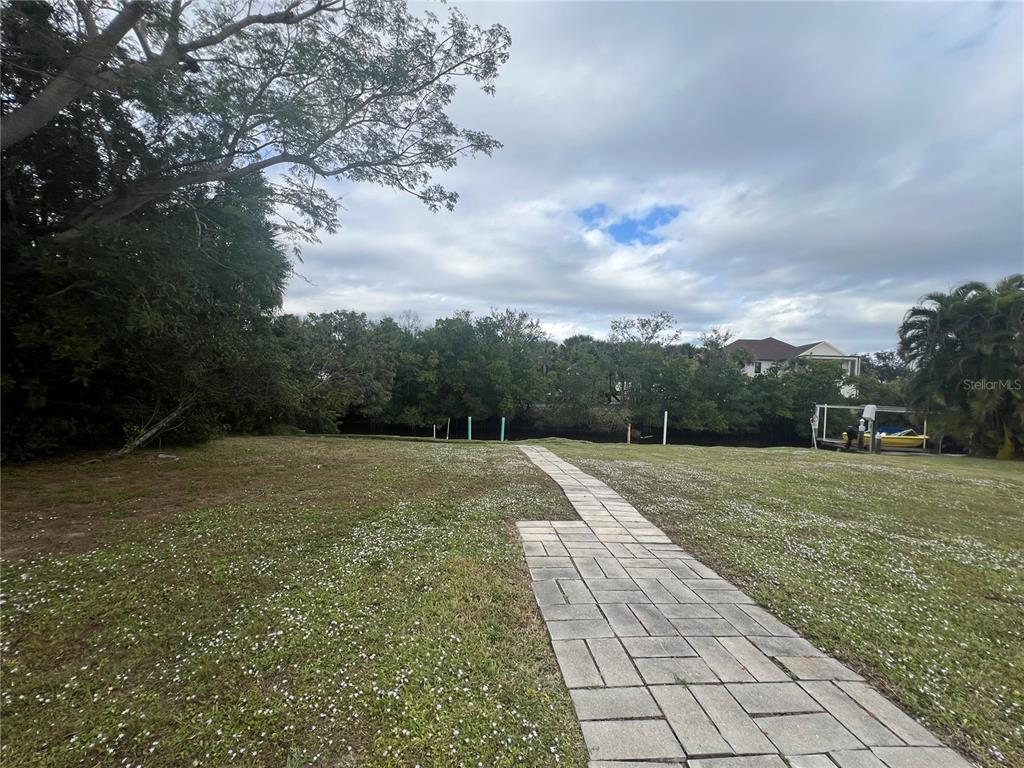 129 Northshore Terrace Punta Gorda, FL 33980 - Photo 31 of 37 a view of outdoor space with green field and trees