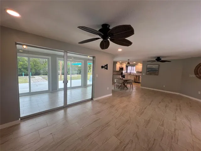 a view of a livingroom with a hardwood floor and ceiling fan
