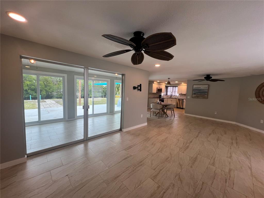 129 Northshore Terrace Punta Gorda, FL 33980 - Photo 4 of 37 a view of a livingroom with a hardwood floor and ceiling fan