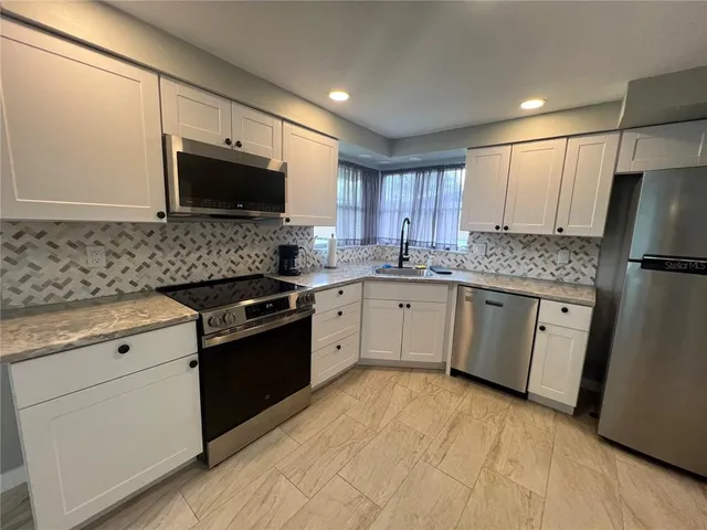 a kitchen with a sink stove and refrigerator