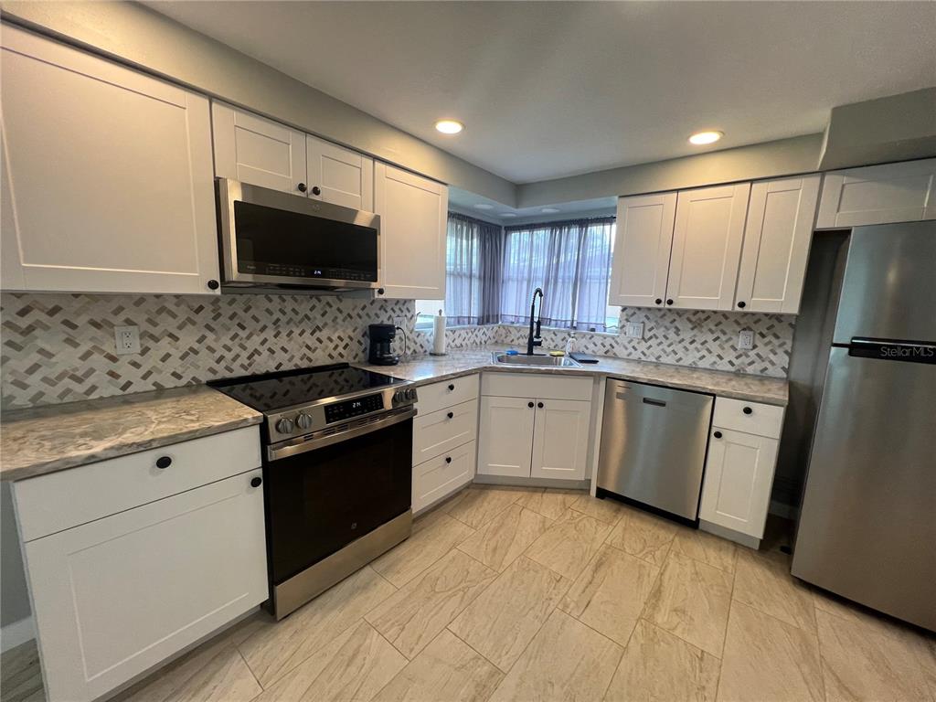 129 Northshore Terrace Punta Gorda, FL 33980 - Photo 7 of 37 a kitchen with a sink stove and refrigerator