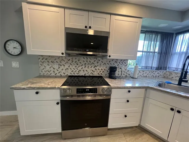 a kitchen with a stove and a sink