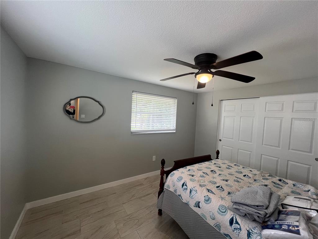 129 Northshore Terrace Punta Gorda, FL 33980 - Photo 10 of 37 a bedroom with a bed and a chandelier