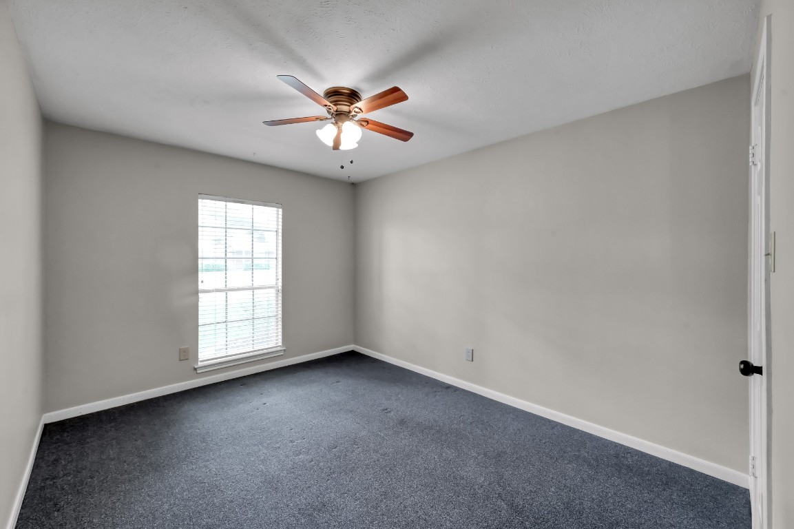 16135 Ridge Park Drive Houston, TX 77095 - Photo 21 of 27 an empty room with windows and fan
