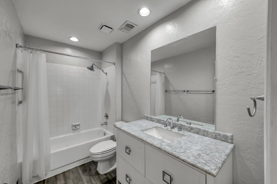 16135 Ridge Park Drive Houston, TX 77095 - Photo 22 of 27 a bathroom with a granite countertop sink a toilet and shower