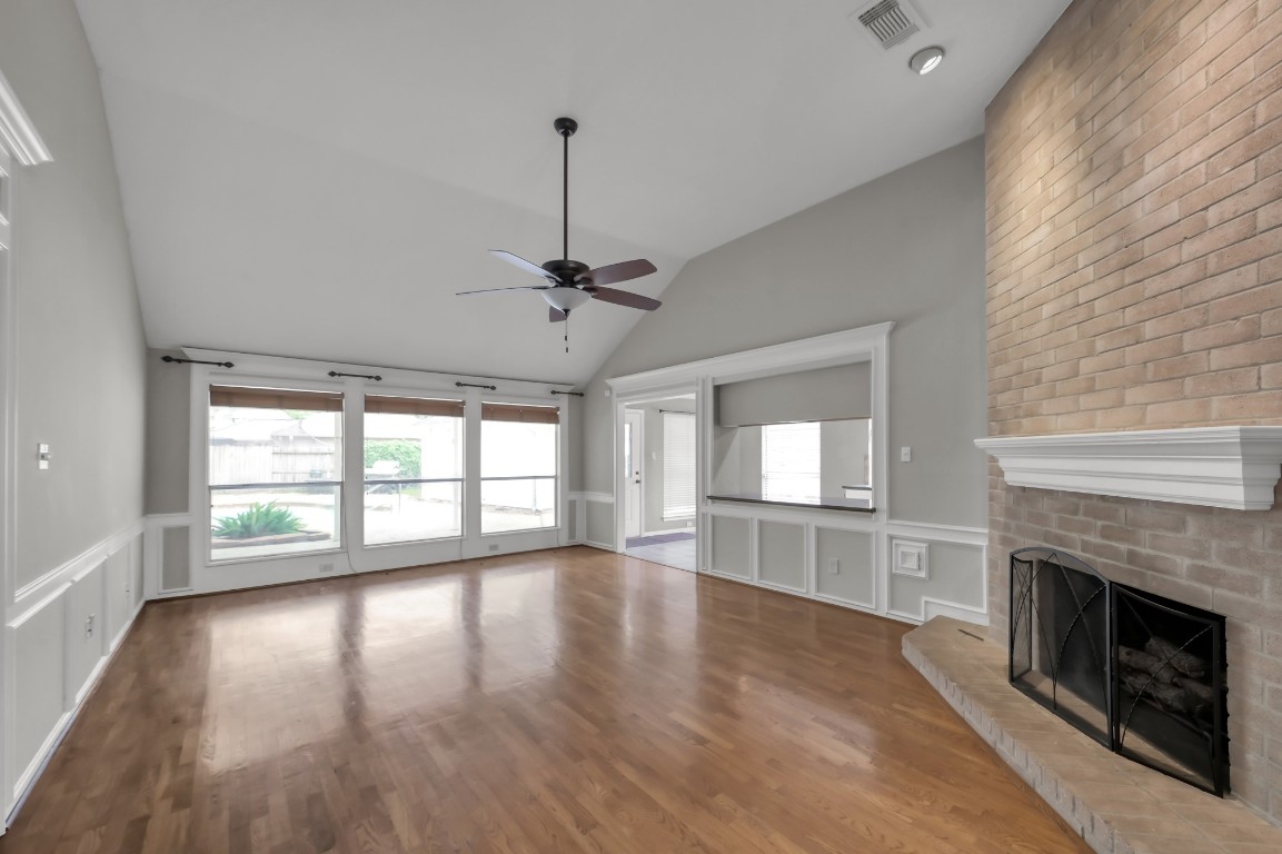 16135 Ridge Park Drive Houston, TX 77095 - Photo 7 of 27 a view of an empty room with a window and wooden floor