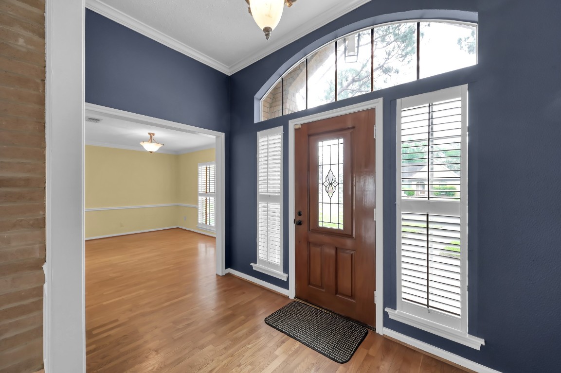 16135 Ridge Park Drive Houston, TX 77095 - Photo 8 of 27 an empty room with wooden floor and windows