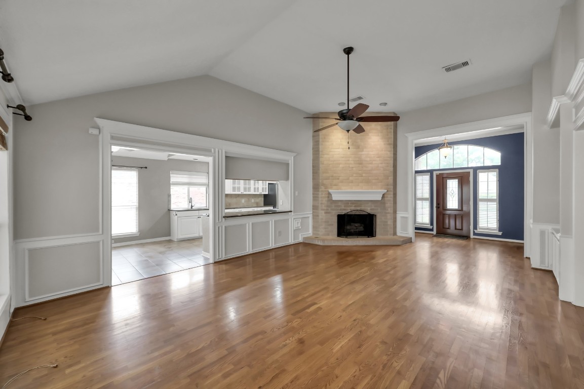 16135 Ridge Park Drive Houston, TX 77095 - Photo 10 of 27 a view of a livingroom with wooden floor a fireplace and windows