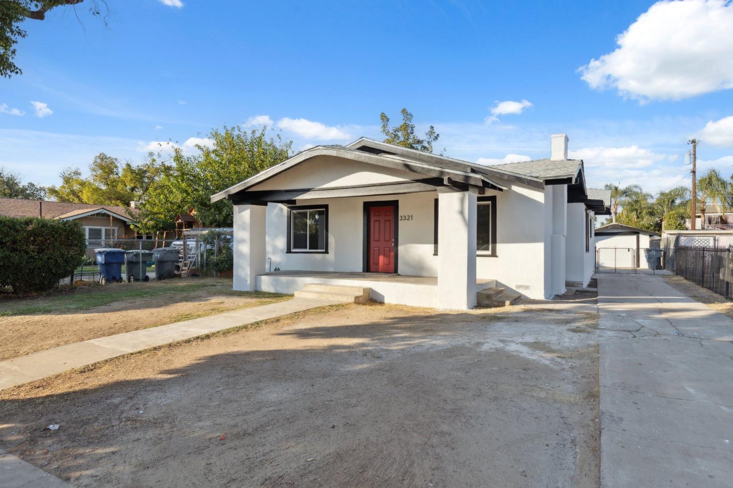 3321 East Montecito Avenue Fresno, CA 93702 - Photo 1 of 22 a front view of a house with a yard