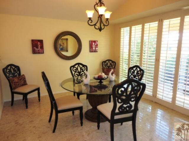 72315 Rodeo Way Rancho Mirage, CA 92270 - Photo 9 of 23 a view of a dining room with furniture and chandelier