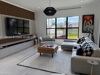 a living room with furniture and a flat screen tv