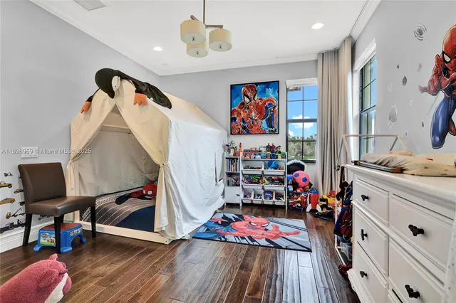 a bedroom with a bed wooden floor and a large window