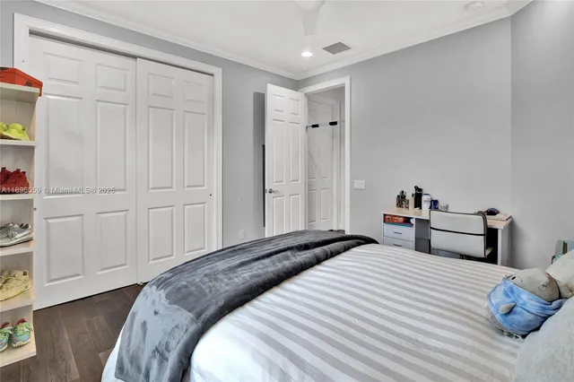 a bathroom with a granite countertop sink a toilet and a mirror