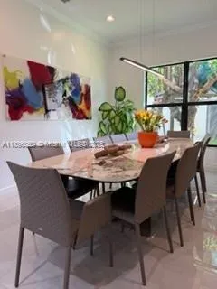 a dining room with furniture and wooden floor