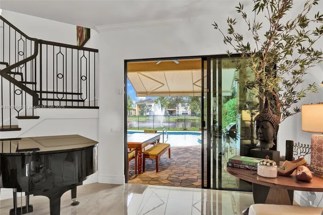 a living room with furniture and a floor to ceiling window