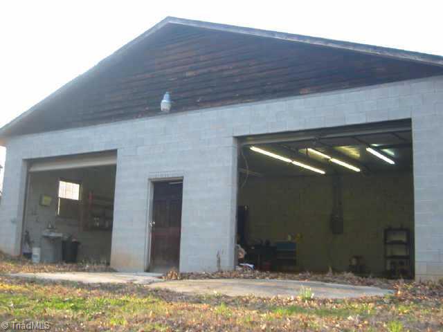 5750 Loop Road Clemmons, NC 27012 - Photo 8 of 9 Other. Detached Garge has 15Ft Ceilings,sink & hydraulic lift in left bay.Stunning garage could probably fit at least 4 cars into this garage(This garage almost looks like Commercial use),but away from main house..down near the woods.