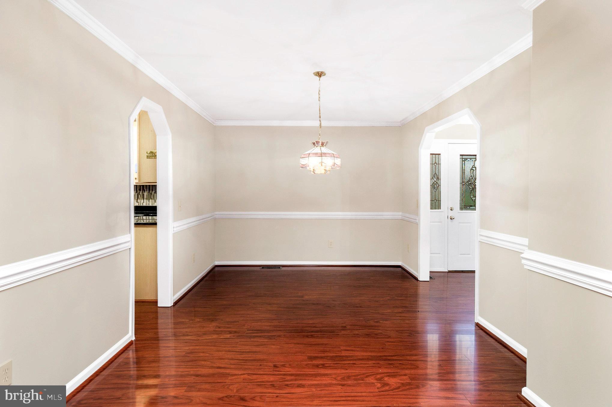 205 Fairway Drive Locust Grove, VA 22508 - Photo 11 of 26 an empty room with wooden floor chandelier and windows