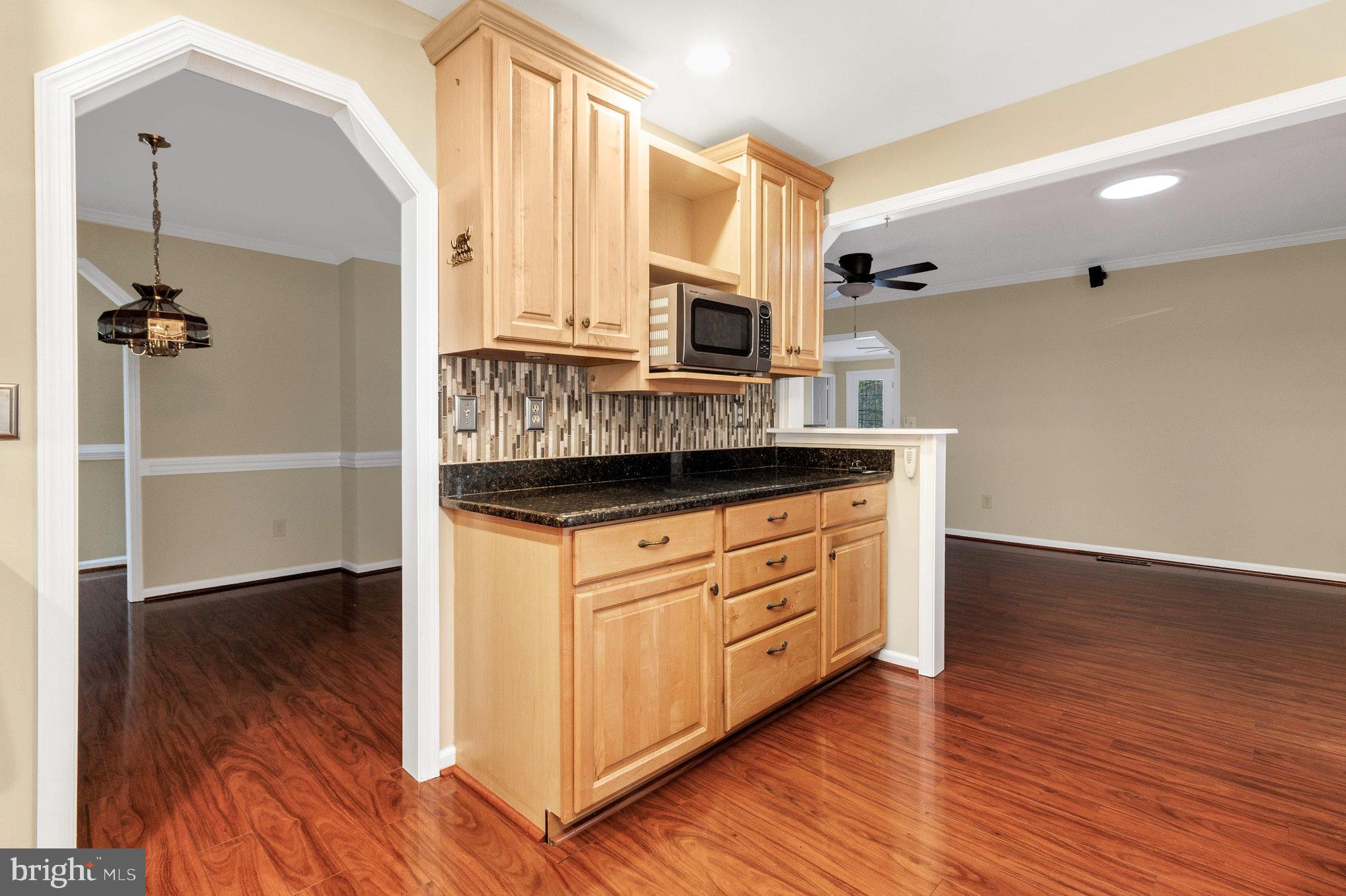 205 Fairway Drive Locust Grove, VA 22508 - Photo 12 of 26 a kitchen with stainless steel appliances granite countertop a refrigerator a stove and a wooden floors