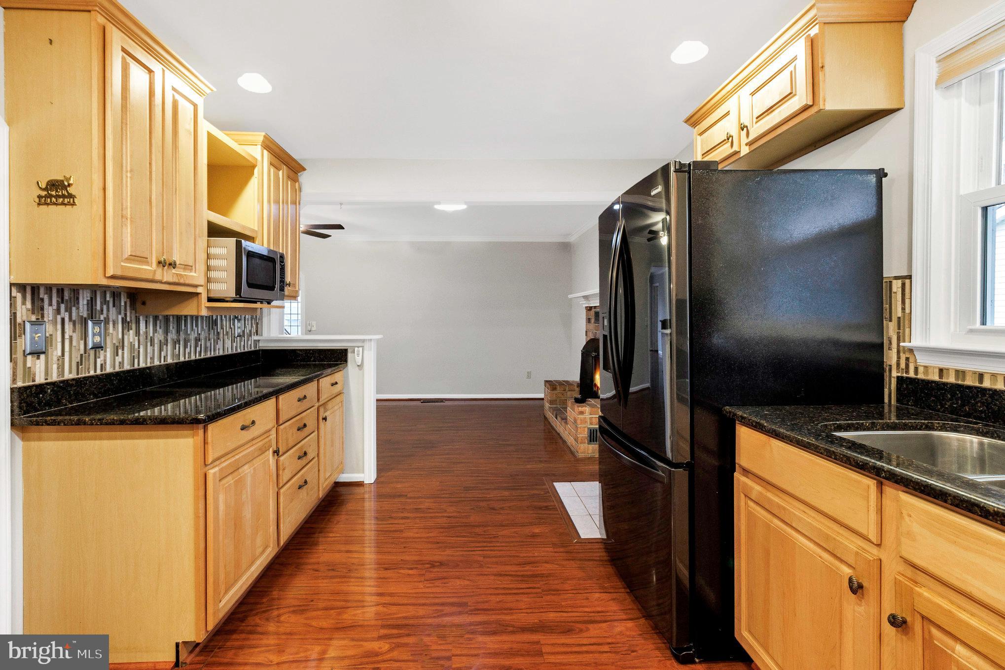 205 Fairway Drive Locust Grove, VA 22508 - Photo 16 of 26 a kitchen with stainless steel appliances granite countertop a sink and a refrigerator