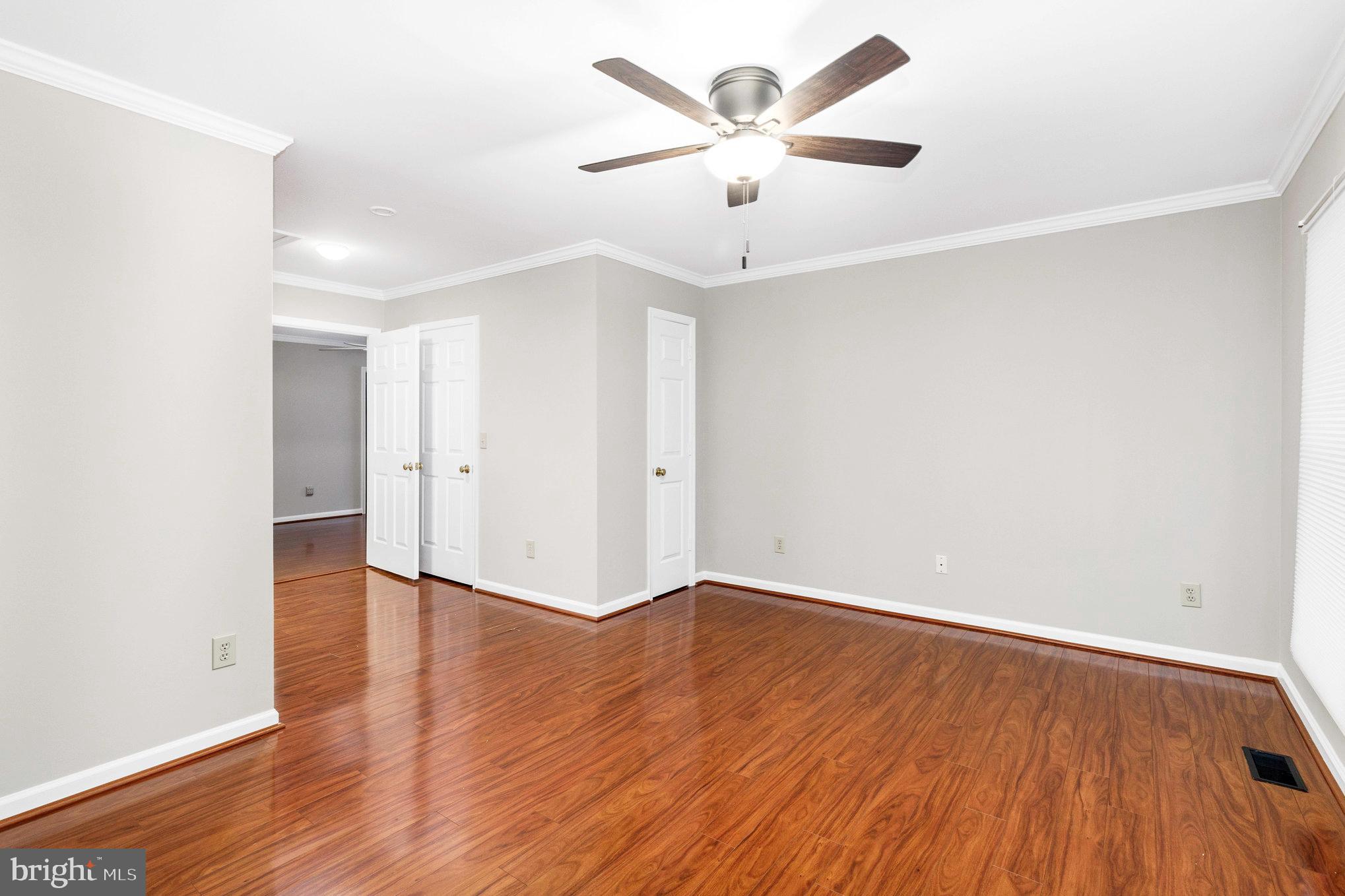 205 Fairway Drive Locust Grove, VA 22508 - Photo 18 of 26 an empty room with wooden floor and ceiling fan