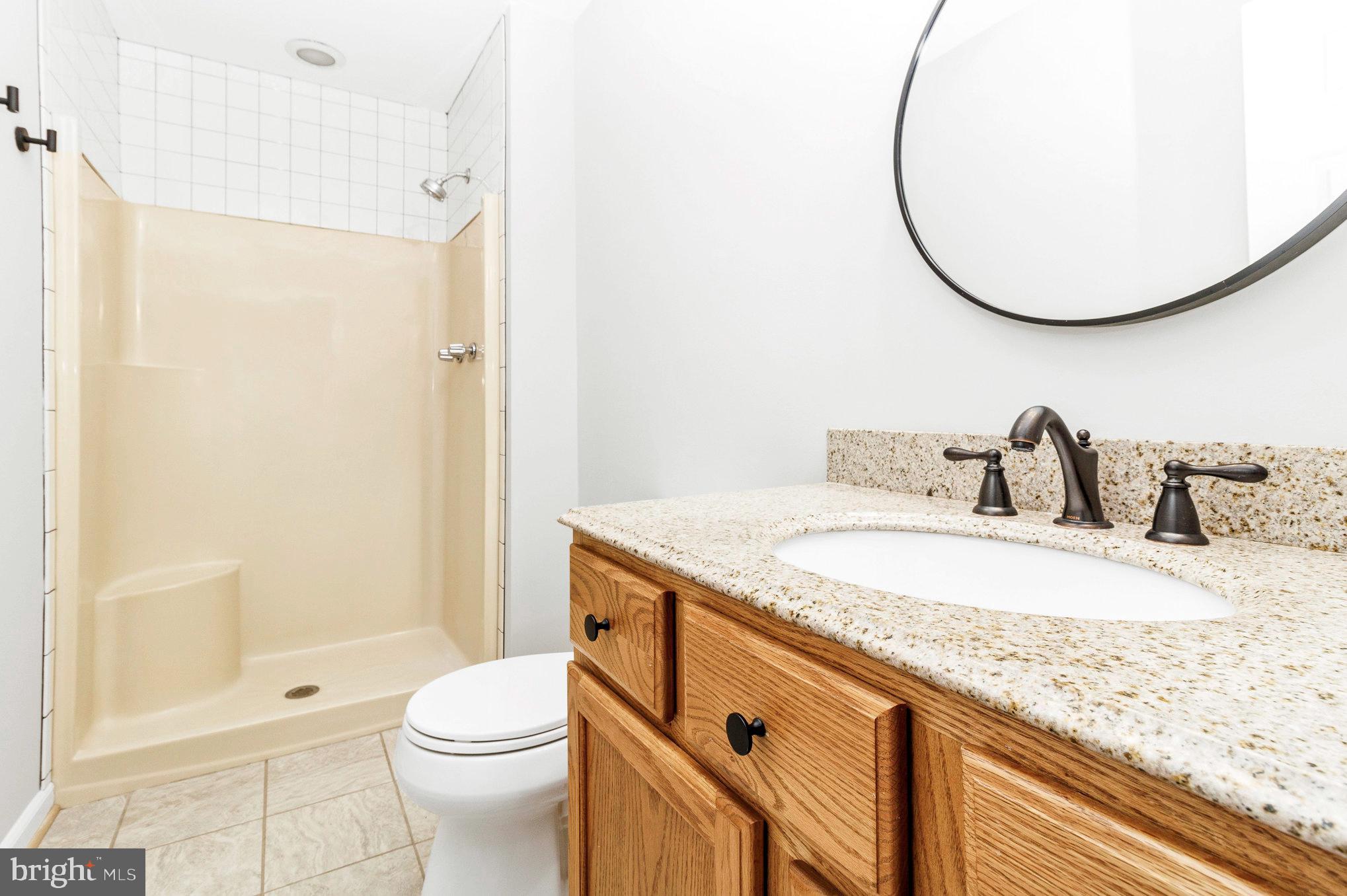 205 Fairway Drive Locust Grove, VA 22508 - Photo 19 of 26 a bathroom with a granite countertop sink toilet and shower