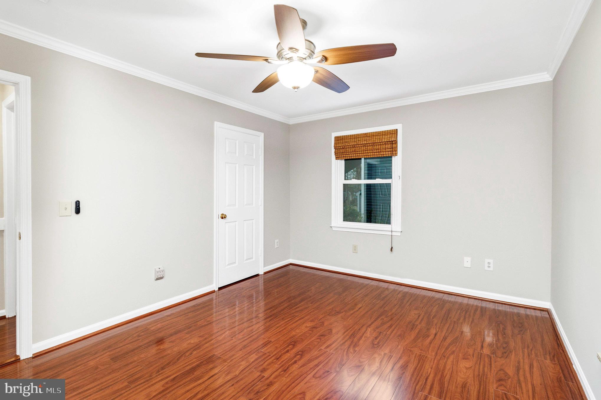 205 Fairway Drive Locust Grove, VA 22508 - Photo 20 of 26 an empty room with wooden floor chandelier fan and windows