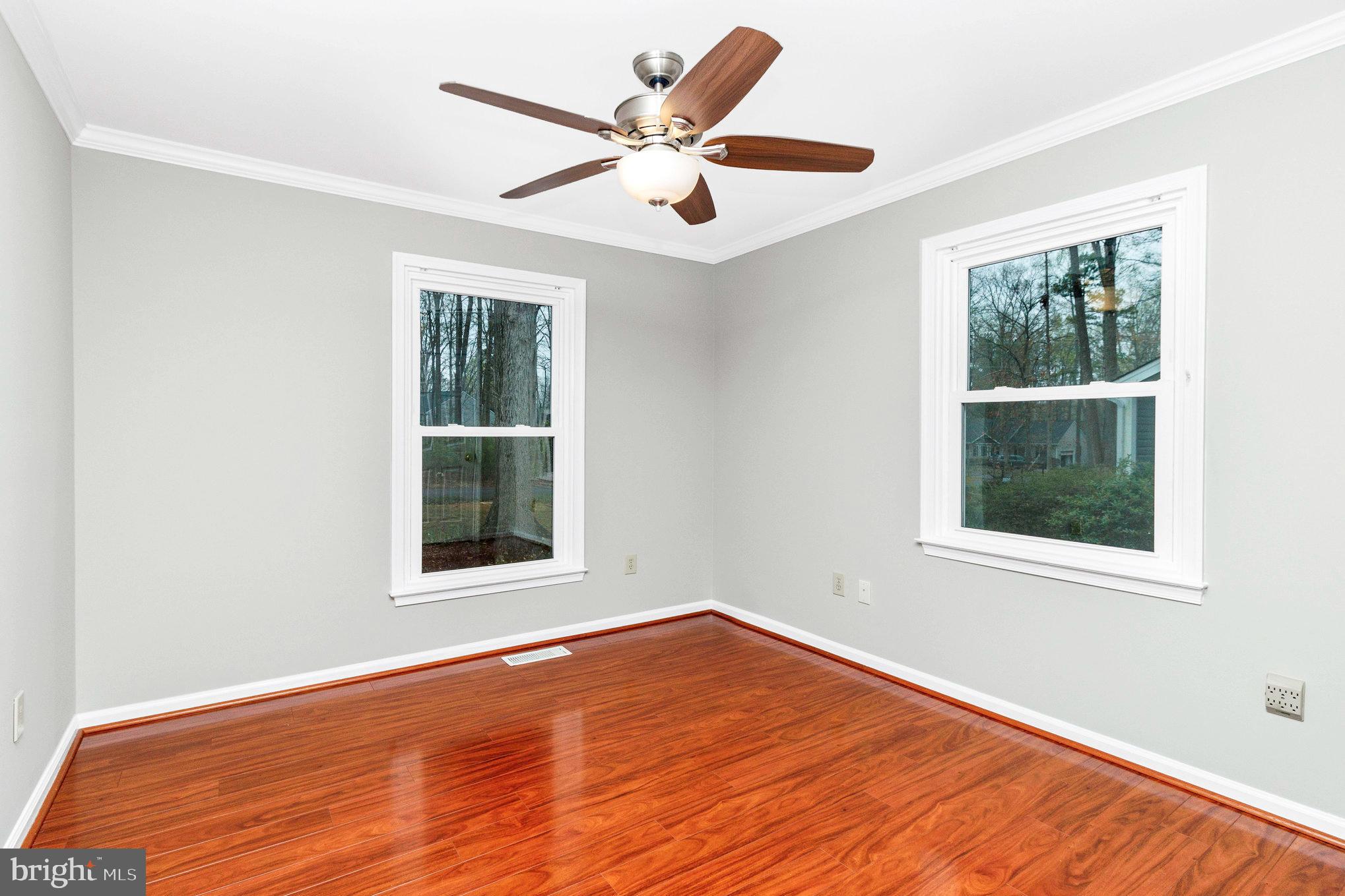 205 Fairway Drive Locust Grove, VA 22508 - Photo 21 of 26 an empty room with wooden floor and windows