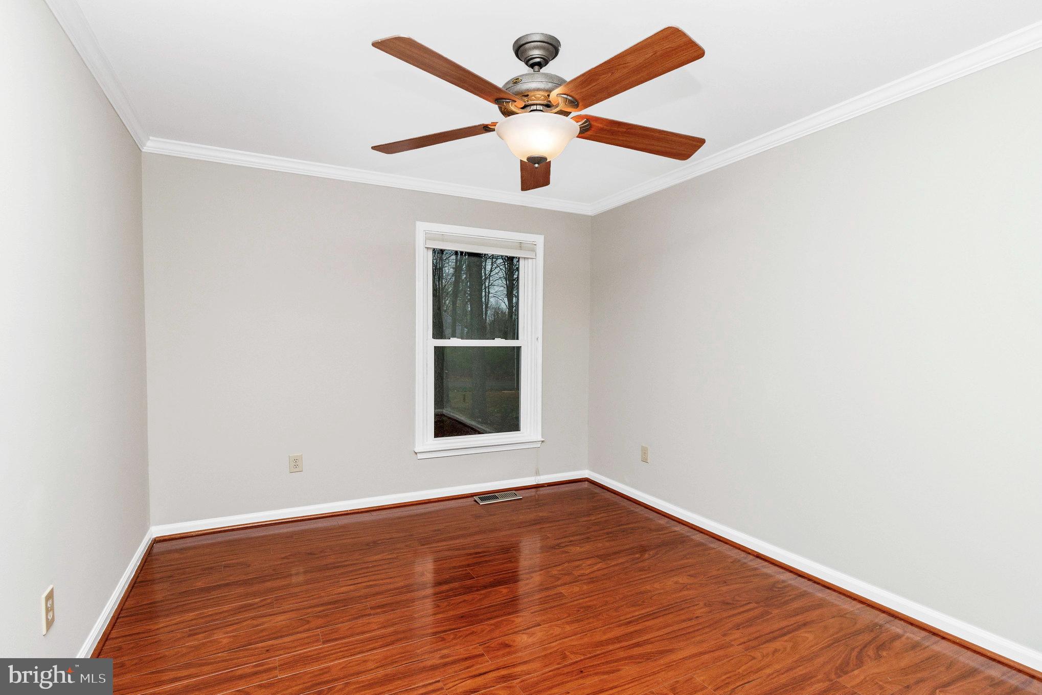 205 Fairway Drive Locust Grove, VA 22508 - Photo 22 of 26 an empty room with wooden floor and windows