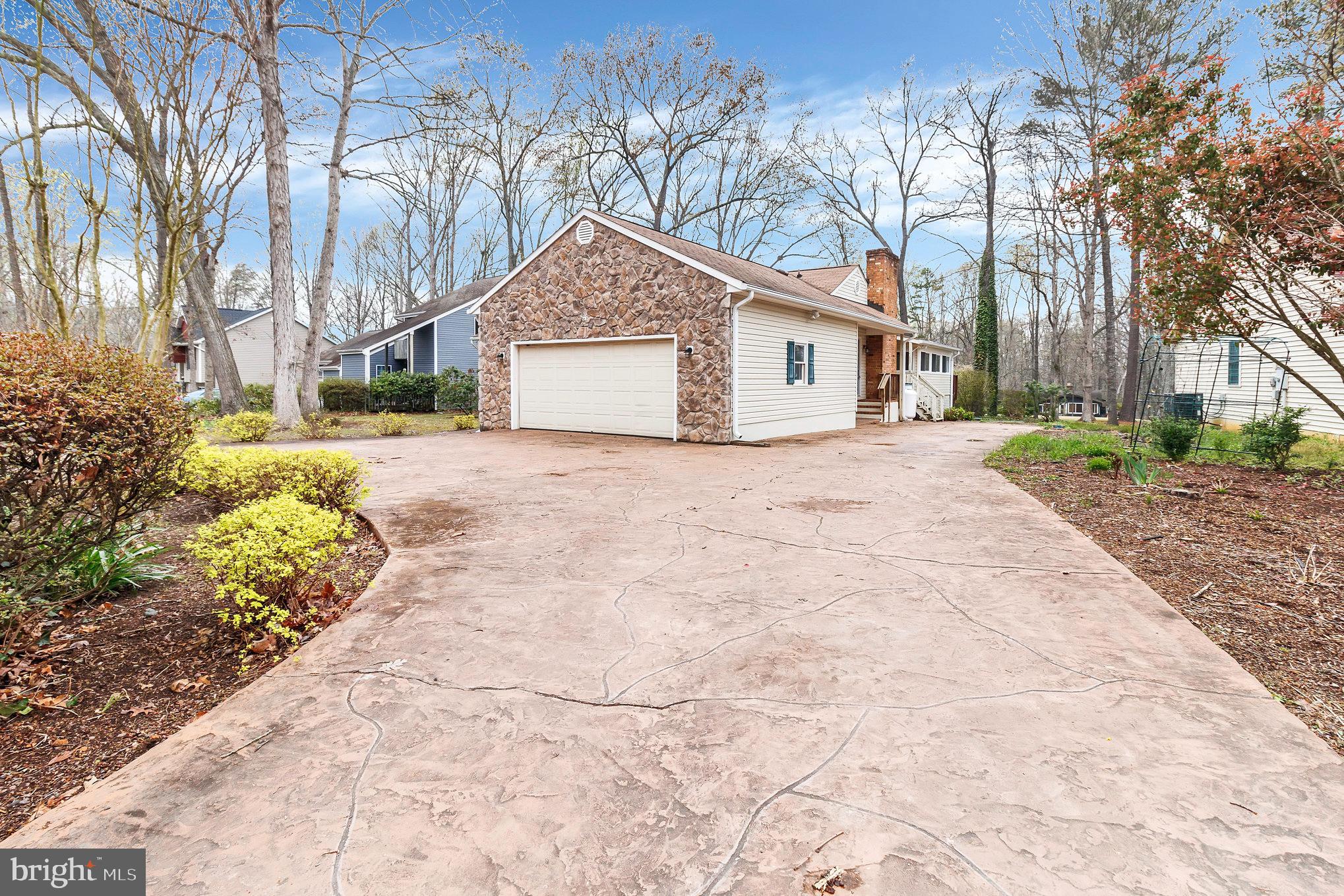 205 Fairway Drive Locust Grove, VA 22508 - Photo 5 of 26 a front view of a house with a yard and garage