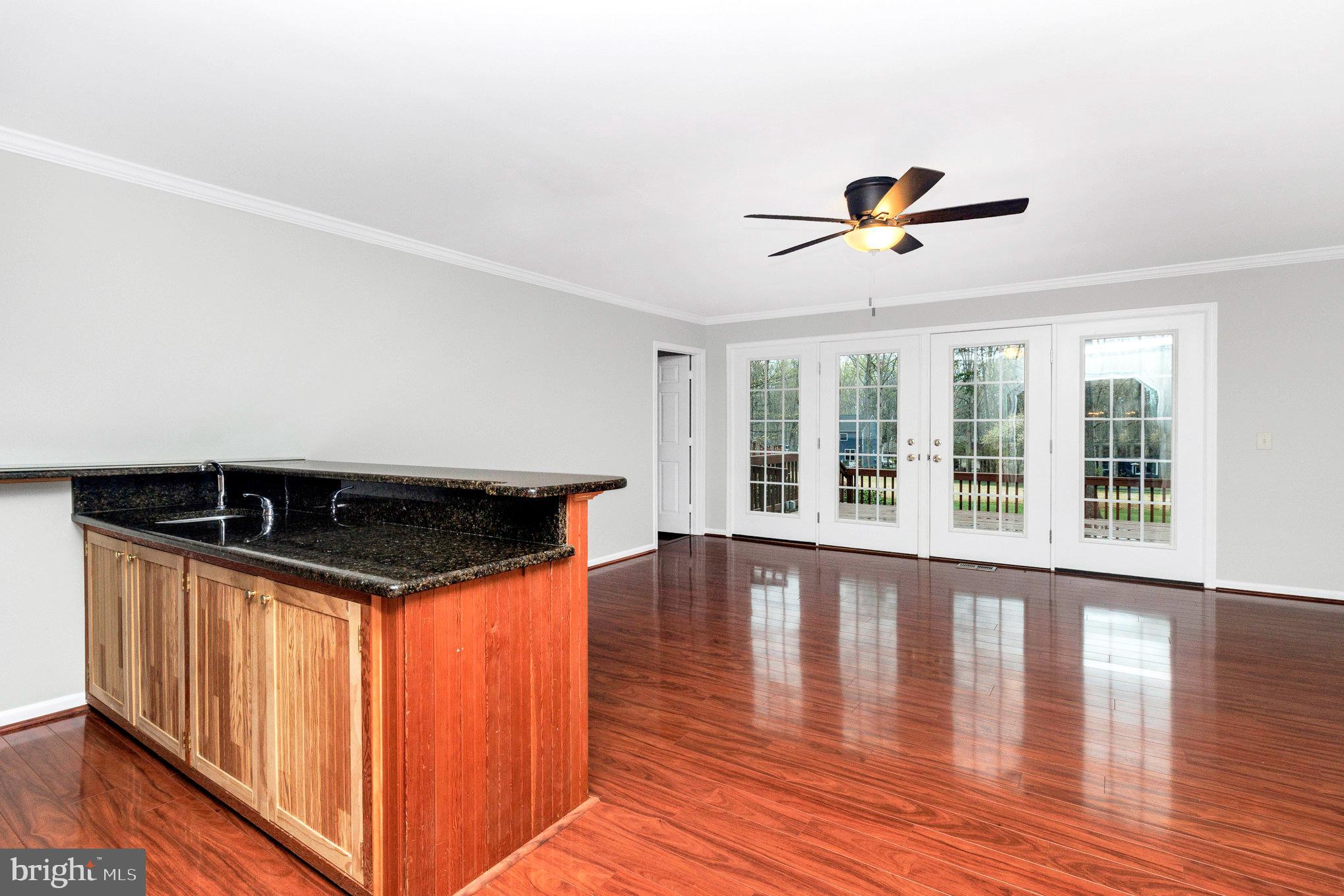 205 Fairway Drive Locust Grove, VA 22508 - Photo 9 of 26 a view of room with wooden floor and ceiling fan