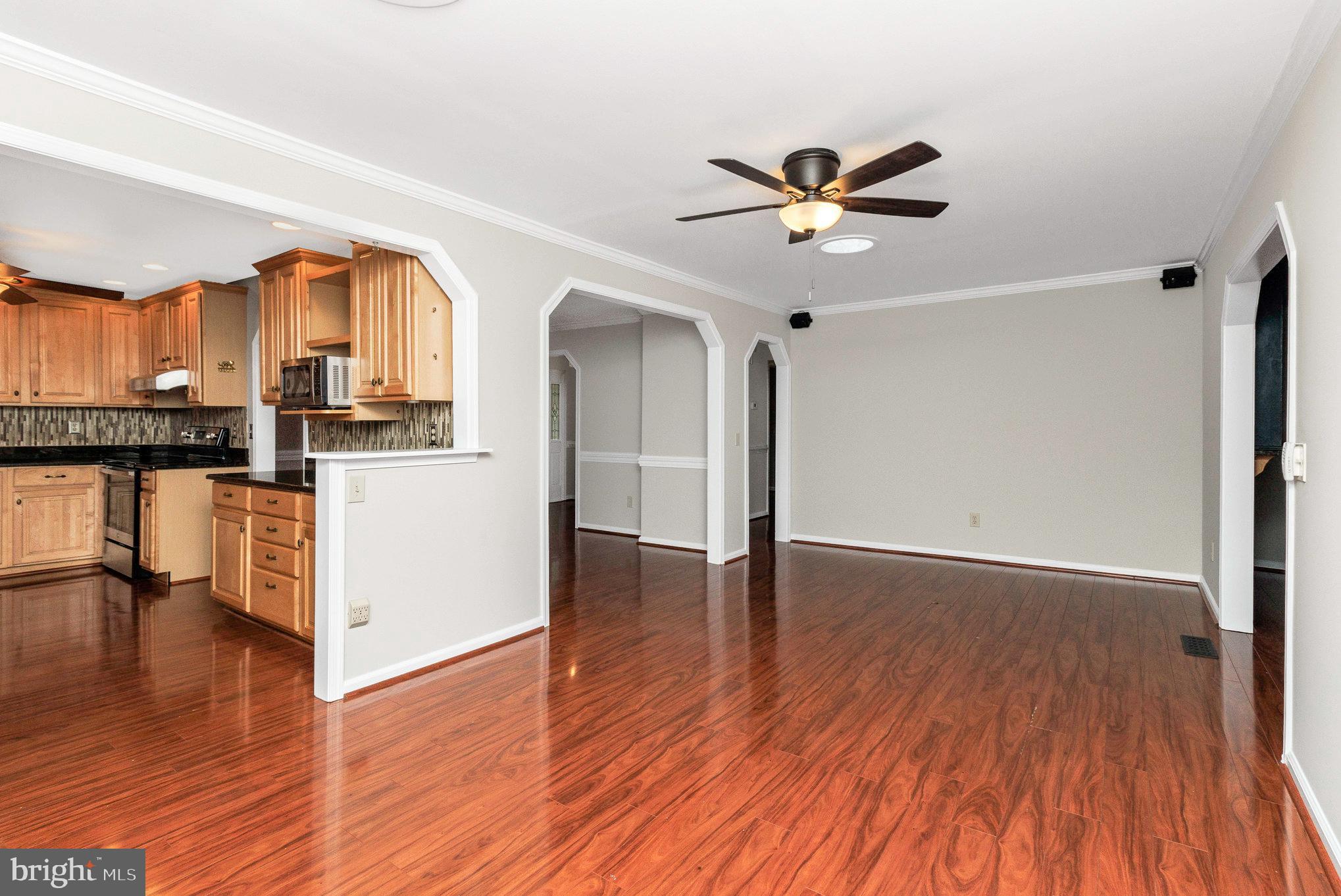 205 Fairway Drive Locust Grove, VA 22508 - Photo 10 of 26 a view of a kitchen with wooden floor and a ceiling fan