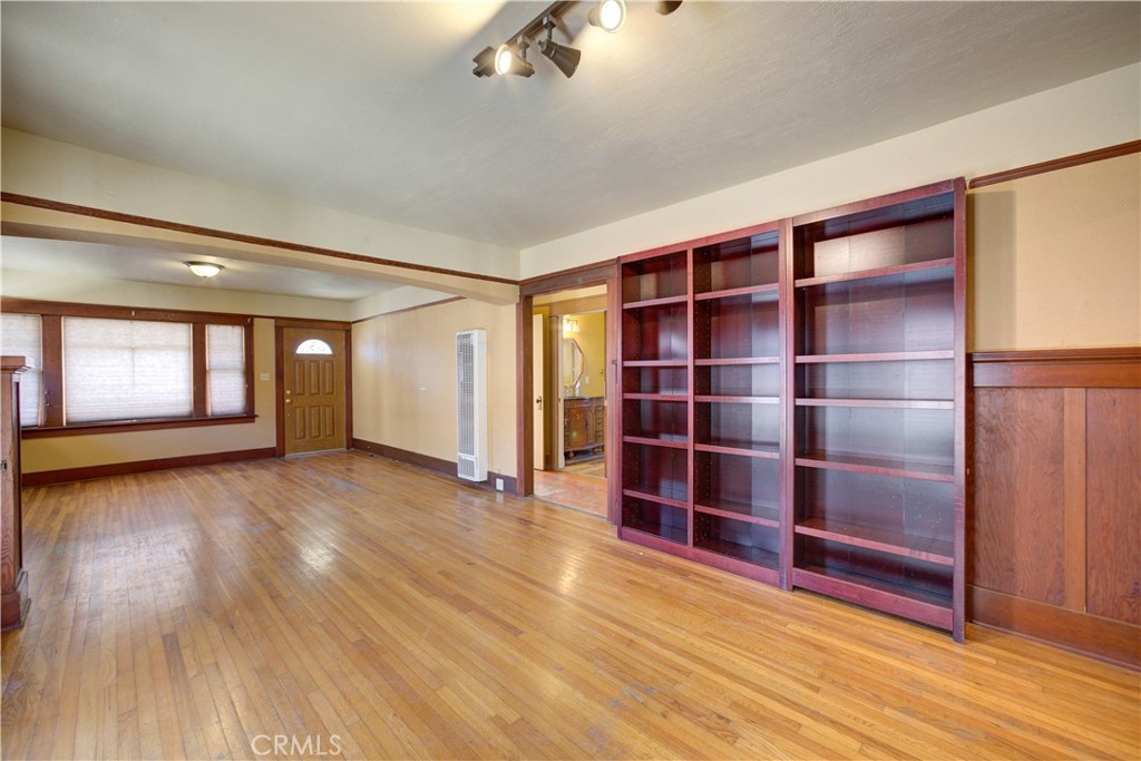 4579 11th Street Guadalupe, CA 93434 - Photo 11 of 40 a view of an empty room with a window and wooden floor