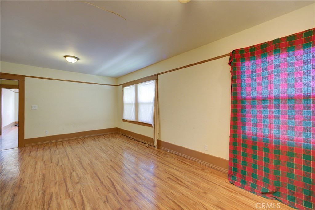 4579 11th Street Guadalupe, CA 93434 - Photo 23 of 40 a view of an empty room with wooden floor and a window
