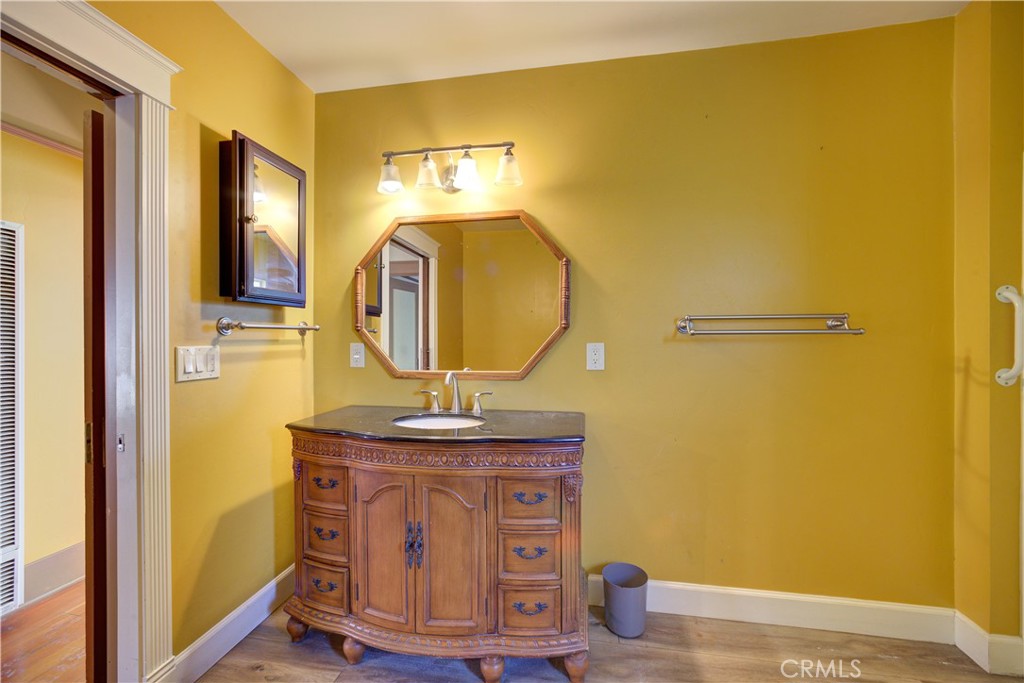 4579 11th Street Guadalupe, CA 93434 - Photo 30 of 40 a bathroom with a sink mirror and vanity
