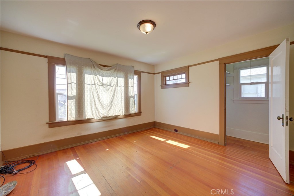 4579 11th Street Guadalupe, CA 93434 - Photo 32 of 40 an empty room with wooden floor and windows
