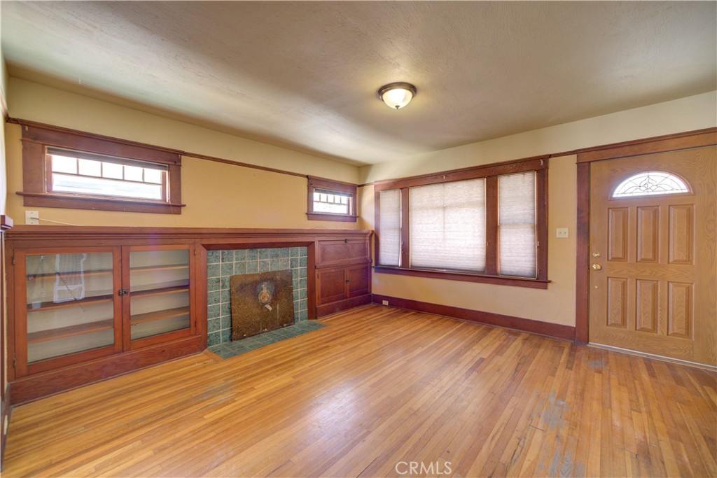 4579 11th Street Guadalupe, CA 93434 - Photo 5 of 40 wooden floor fireplace and windows in an empty room
