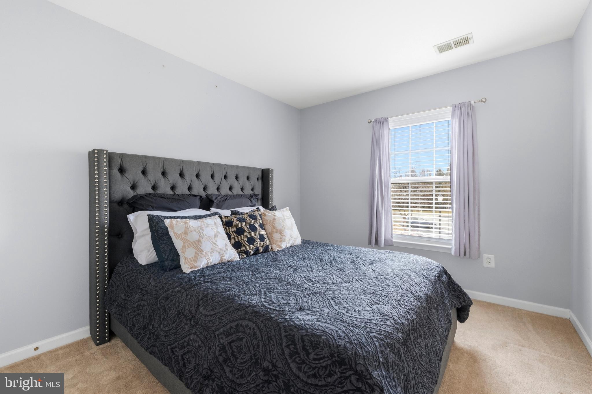 2030 Rosecrans Court Frederick, MD 21702 - Photo 21 of 33 a large bed sitting in a bedroom next to a window