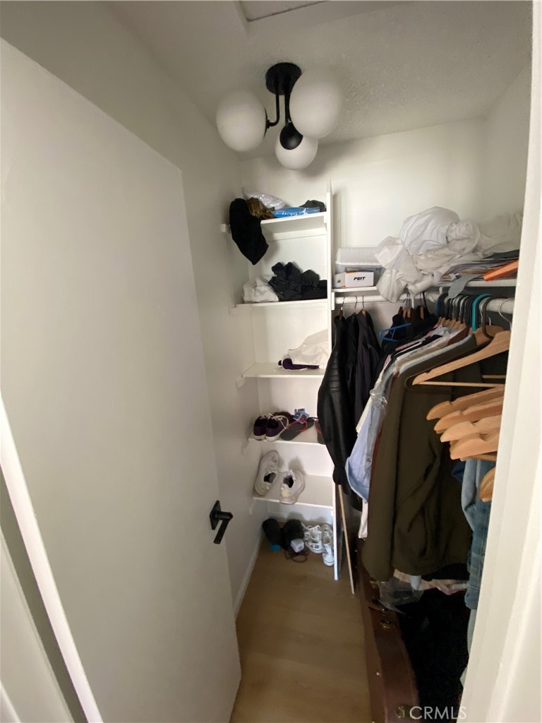 732 Eastshore Terrace, Unit 77 Chula Vista, CA 91913 - Photo 14 of 19 a view of walk in closet with clothes and shoes